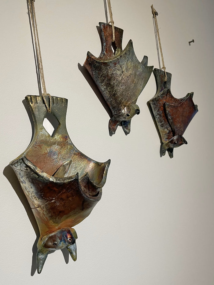 ceramic wall hanging of a bat